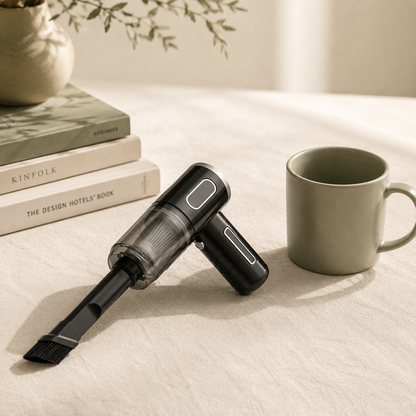 Nooma Mini next to a sage ceramic mug and design books on cream linen
