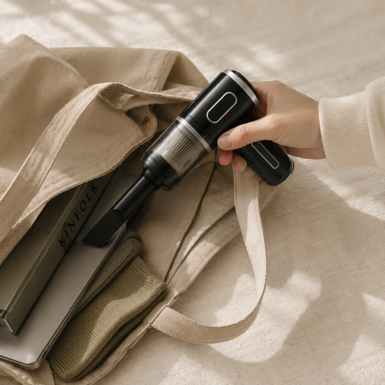 Nooma Mini being placed into a canvas tote bag, lifestyle portability shot